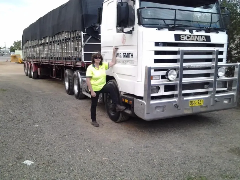 Woman Standing Beside a White Scania Semi-truck on a Gravel Lot — Western Pacific Operations in Kremnos, NSW
