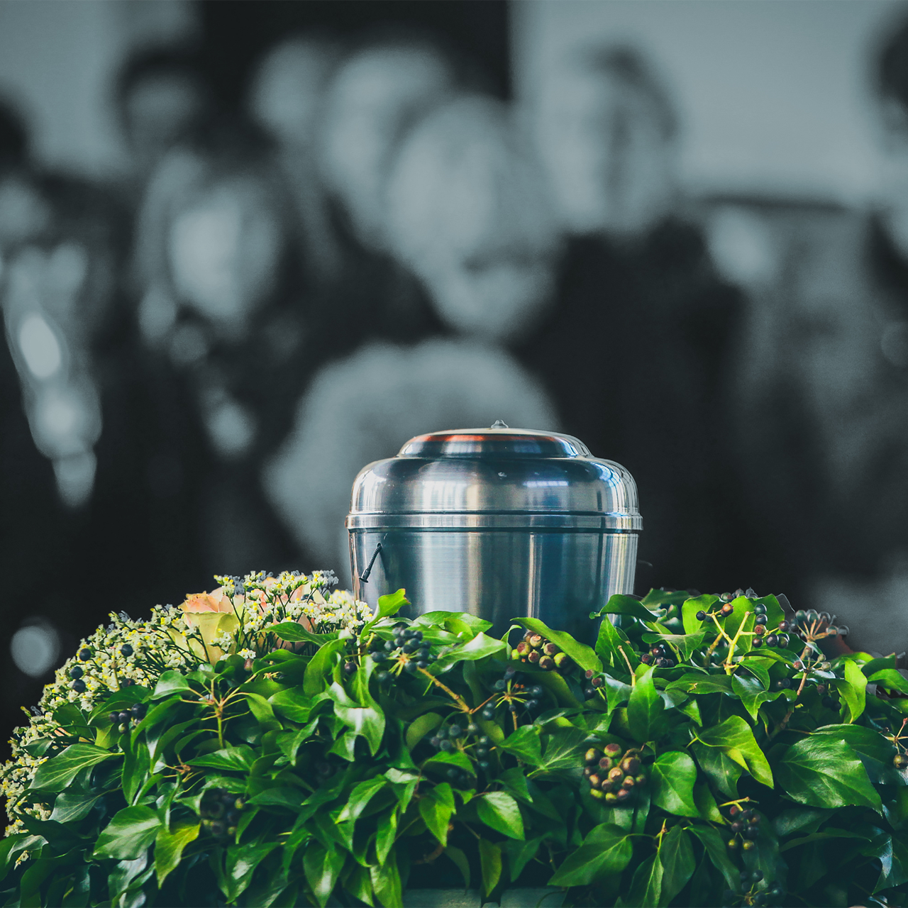 A bouquet of flowers is sitting on top of a grave in a cemetery.