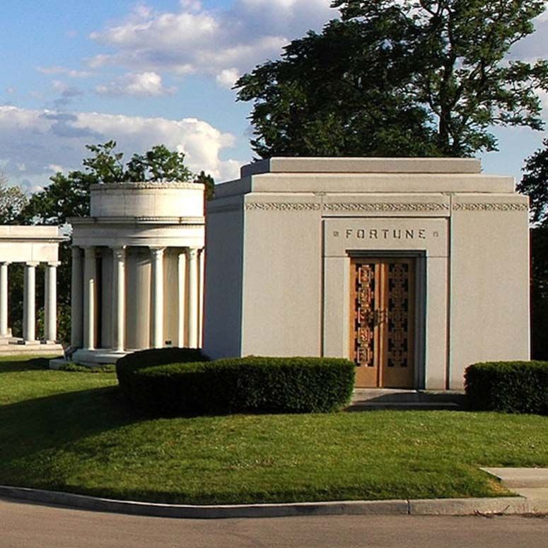 A bouquet of flowers is sitting on top of a grave in a cemetery.