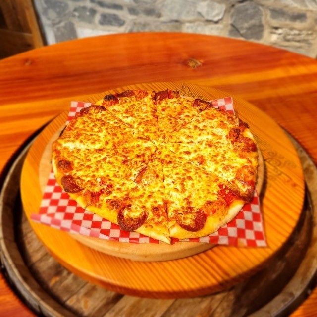 A pizza sitting on top of a wooden cutting board