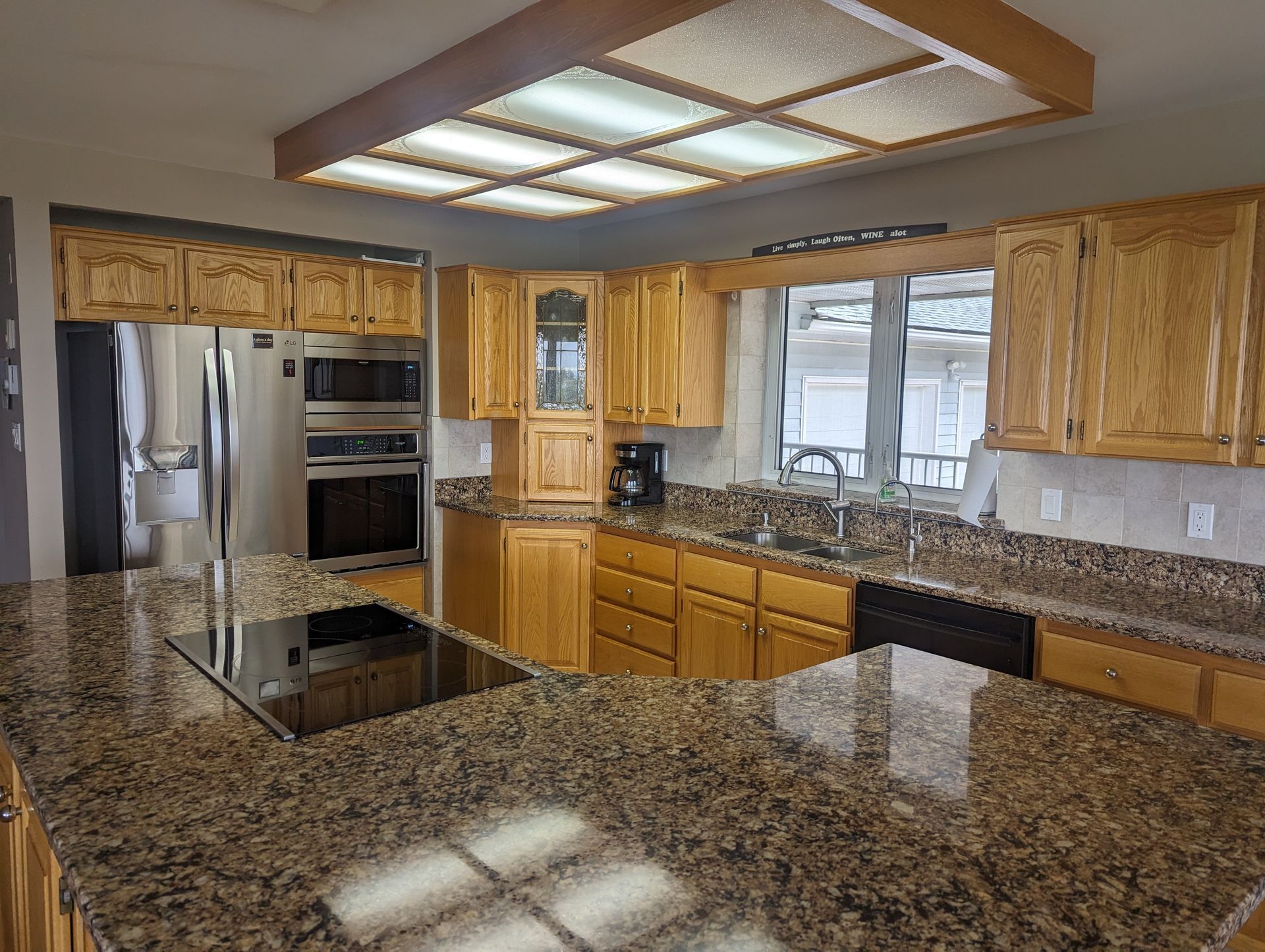 A kitchen with granite counter tops and stainless steel appliances