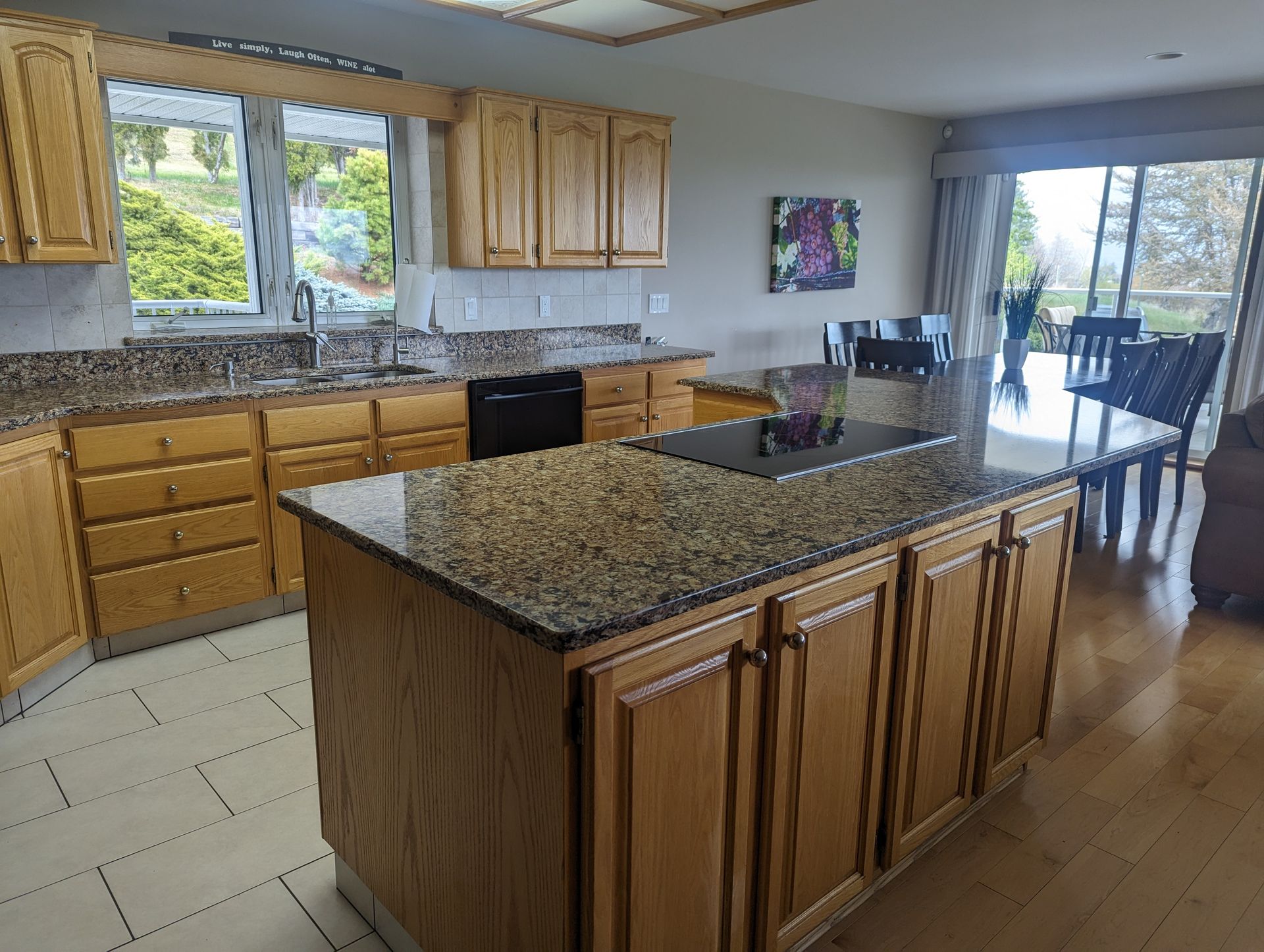 A kitchen with wooden cabinets and granite counter tops
