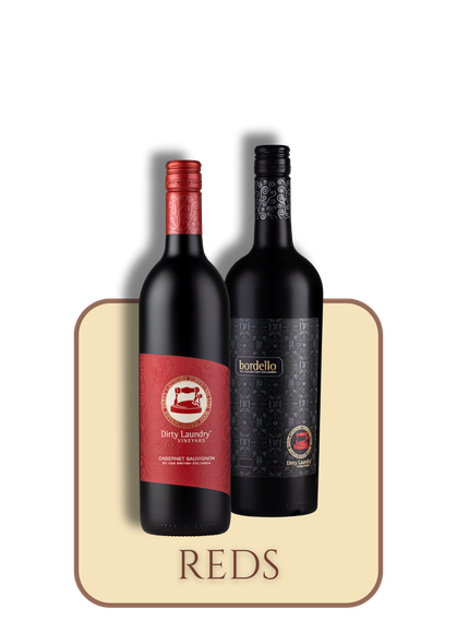 Two bottles of red wine are sitting next to each other on a table.
