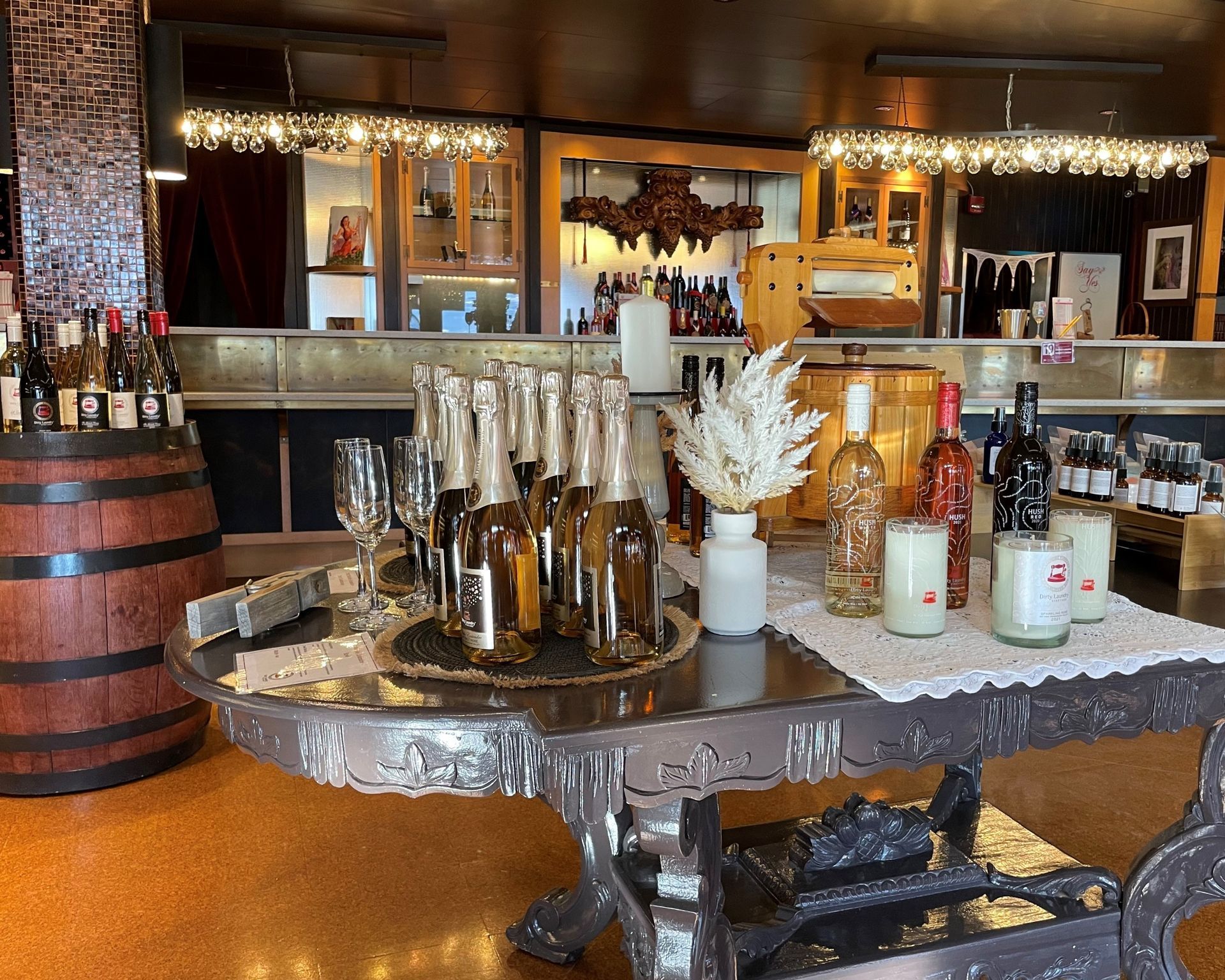 A table with bottles of wine and candles on it