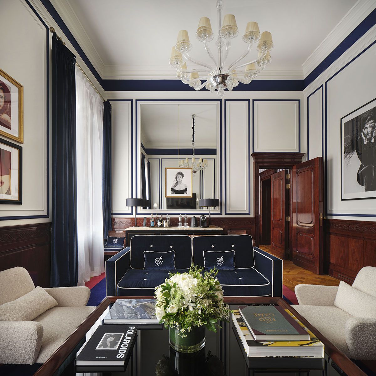 A living room filled with furniture and a vase of flowers