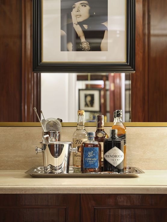 A picture of a woman is above a tray of liquor