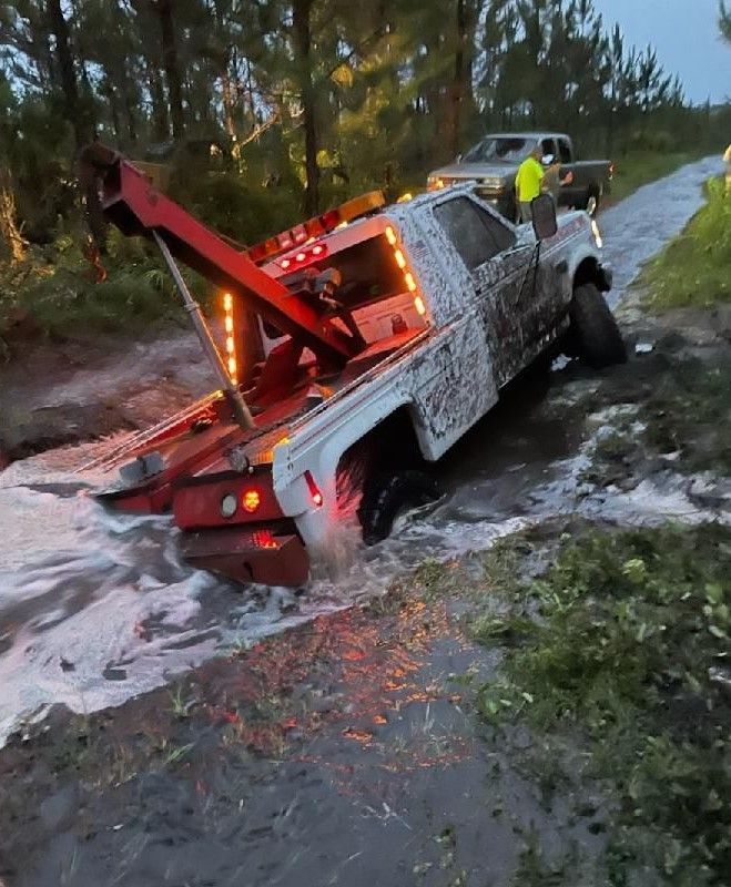 Red Truck Towing the White Truck — Palatka, FL — Johnson's Towing