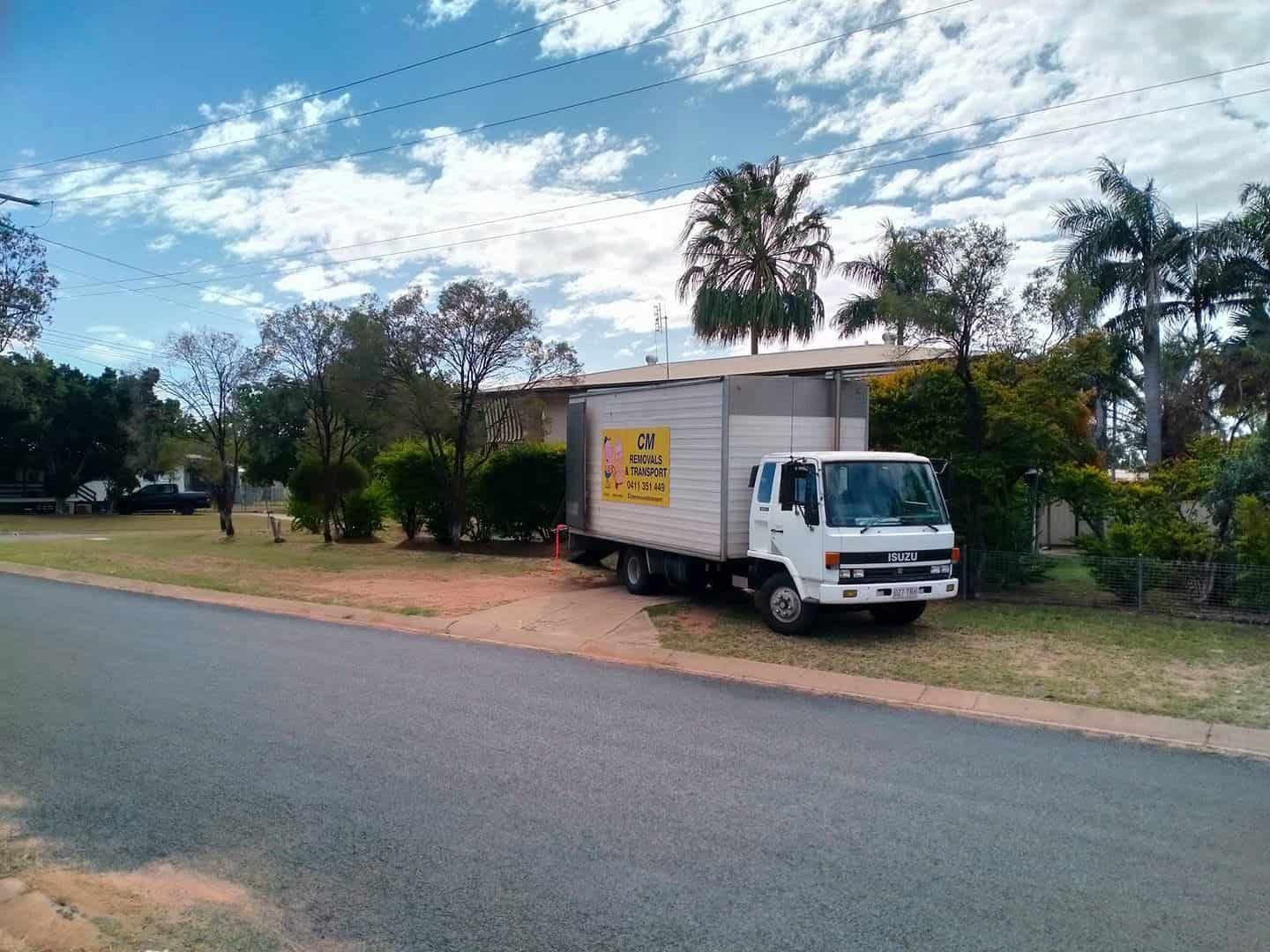a White Moving Truck is Parked on the Side of the Road — CM Removals & Transport In Gympie, QLD