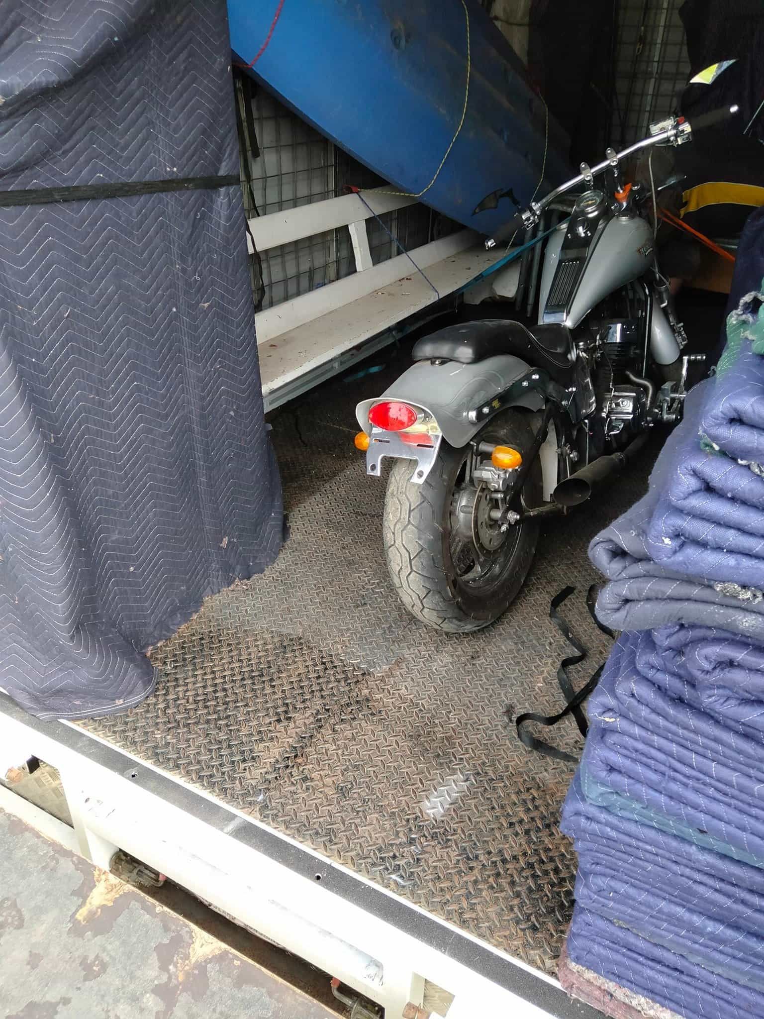 A motorcycle is sitting in the back of a truck. — CM Removals & Transport In Hervey Bay, QLD