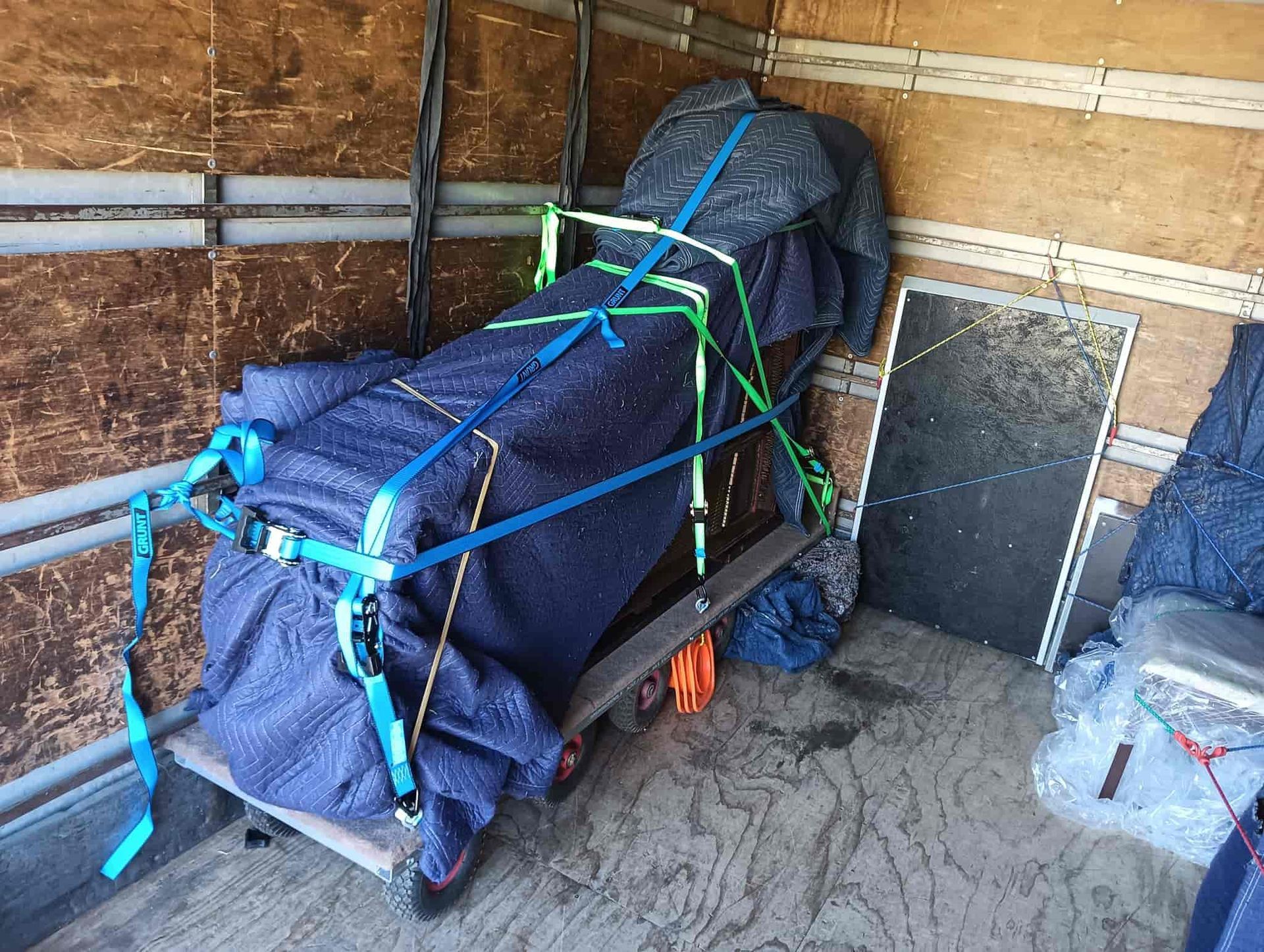 A piano is sitting on a cart in a moving truck. — CM Removals & Transport In Gympie, QLD