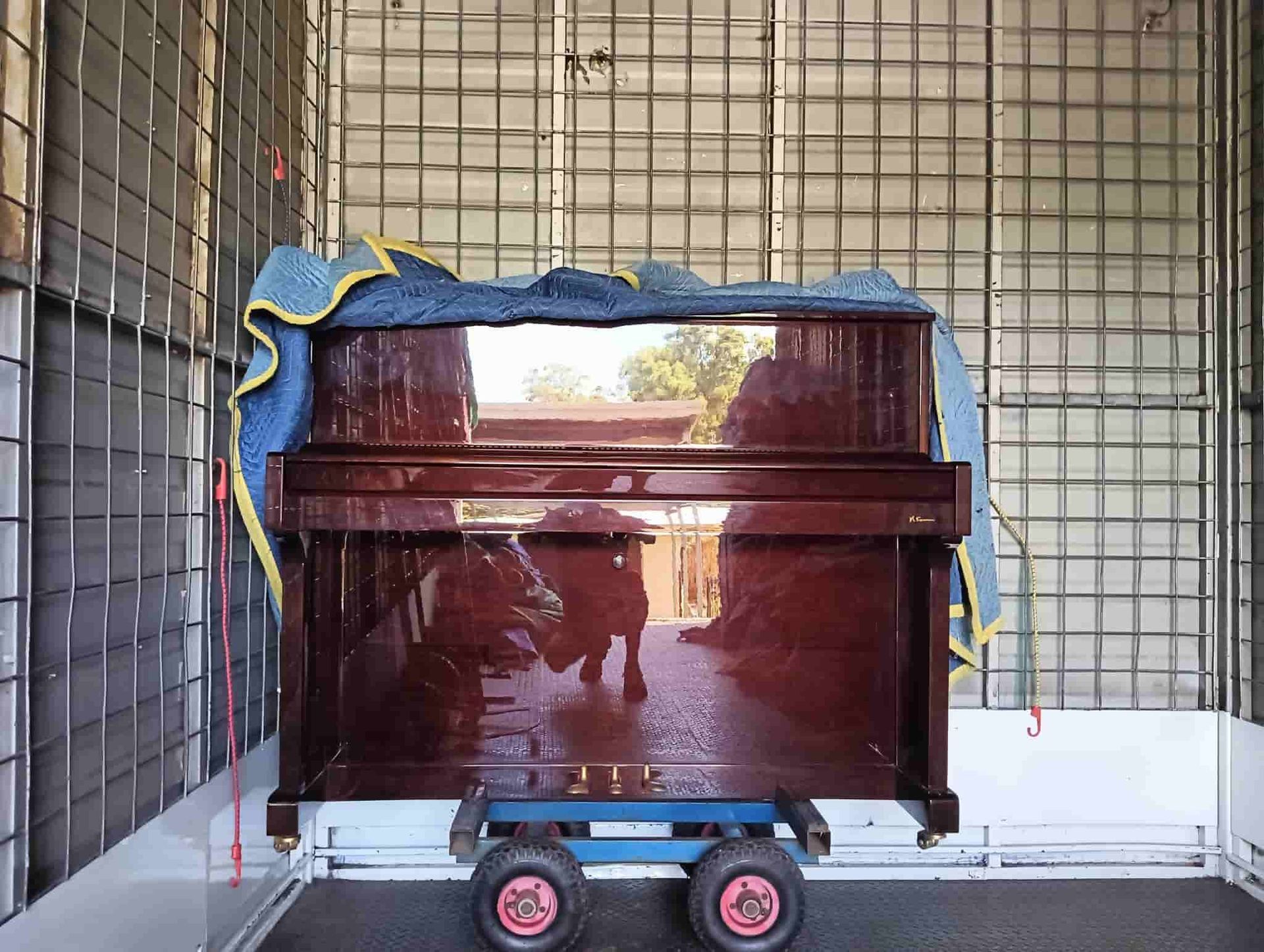 a Piano is Sitting on a Cart in a Moving Truck — CM Removals & Transport In Tin Can Bay, QLD