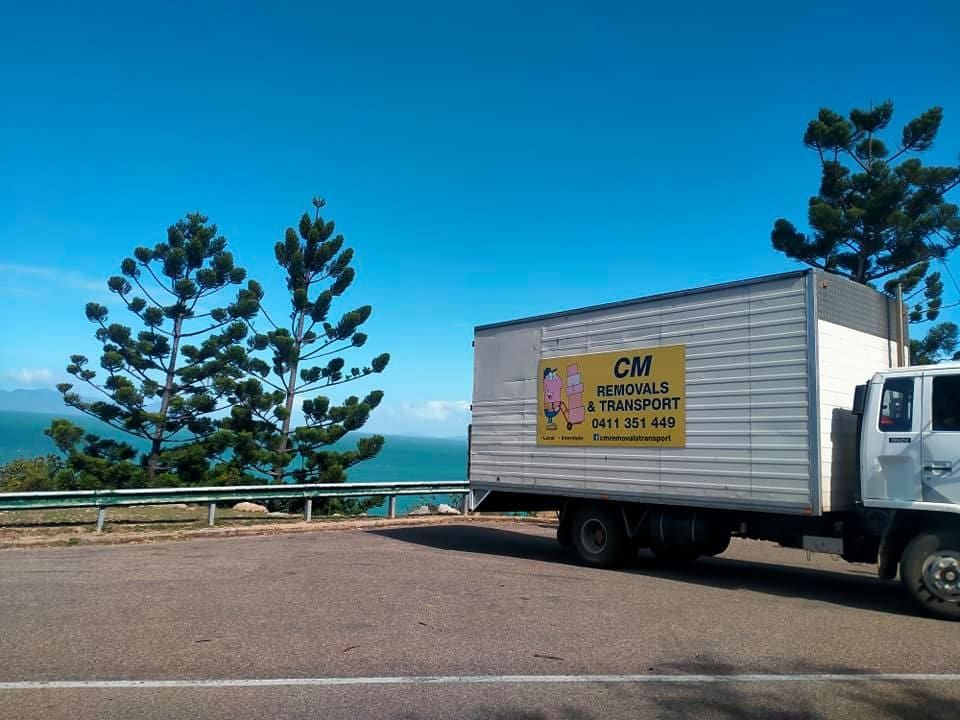 a Cm Moving Truck is Parked on the Side of the Road — CM Removals & Transport In Sunshine Coast, QLD