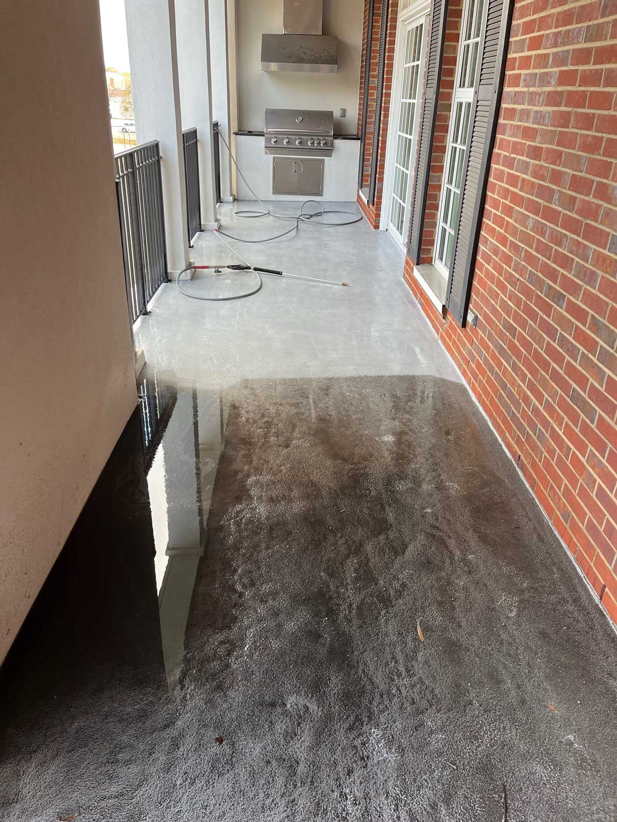 Balcony pressure washing in progress