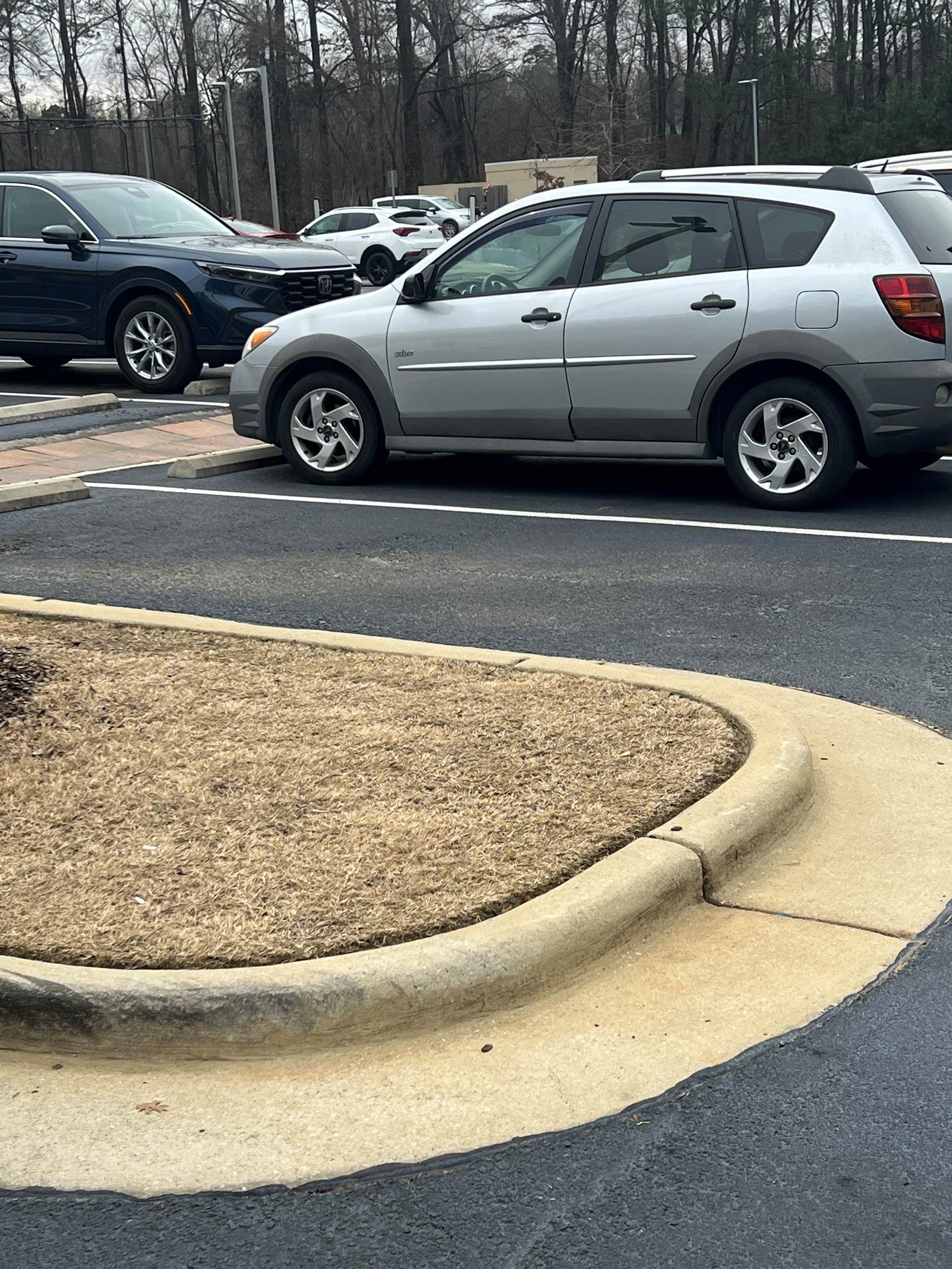 Parking lot with vehicles and curb