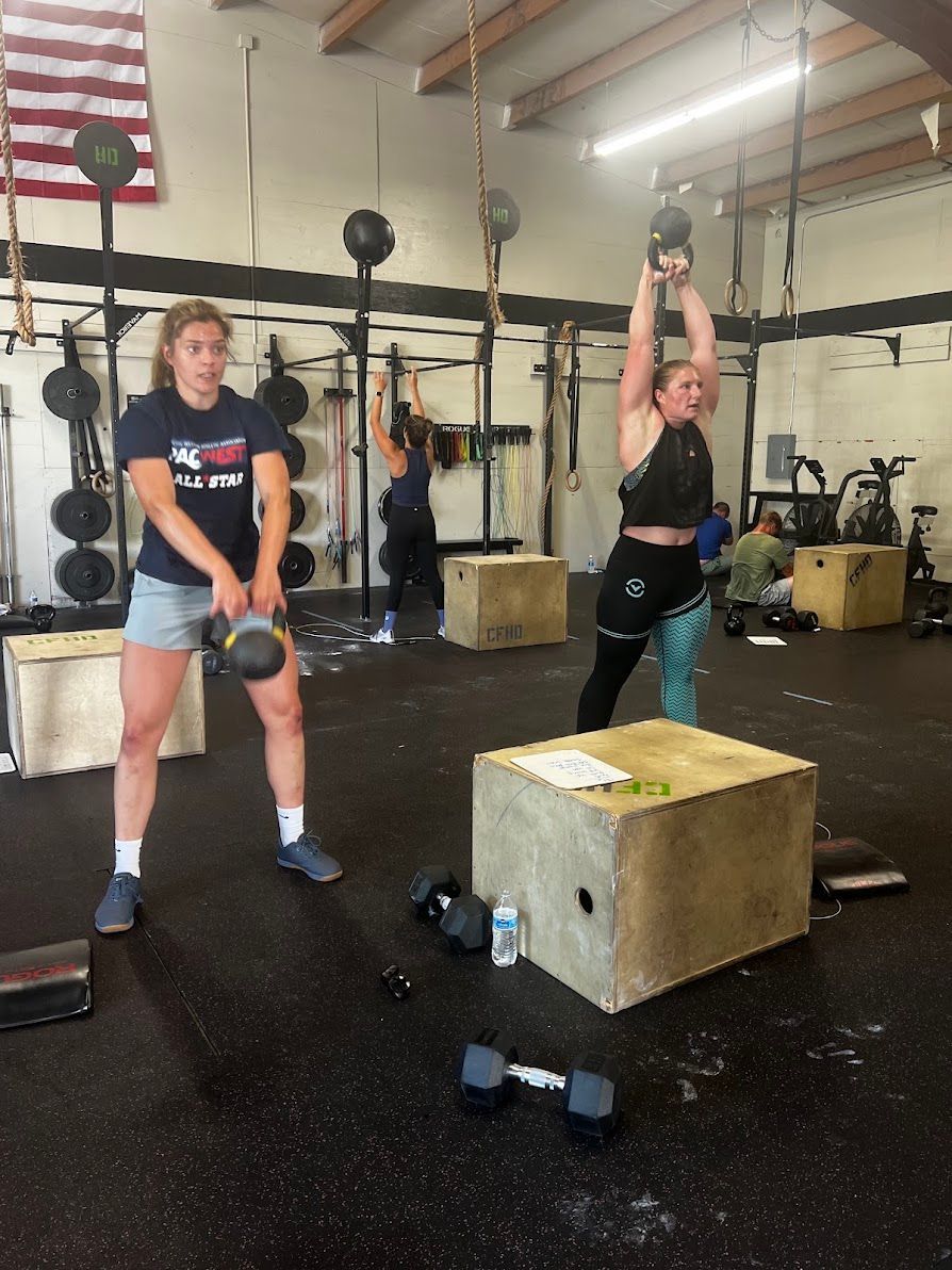 People exercising in a large industrial gym in Lynden, WA with ropes and kettlebells