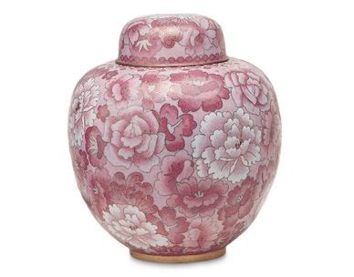 A pink vase with flowers on it and a lid
