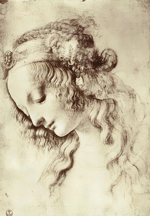 Persone che disegnano a un tavolo; disegni di volti e figure; mani che lavorano; l'ambientazione sembra quella di una lezione o di un laboratorio.