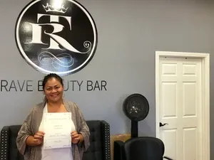 Happy woman holding certificate | Sylmar, CA | Rave Beauty Bar