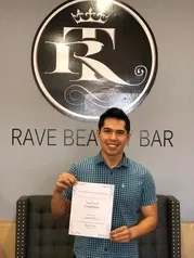 Man in blue polo holding certificate | Sylmar, CA | Rave Beauty Bar