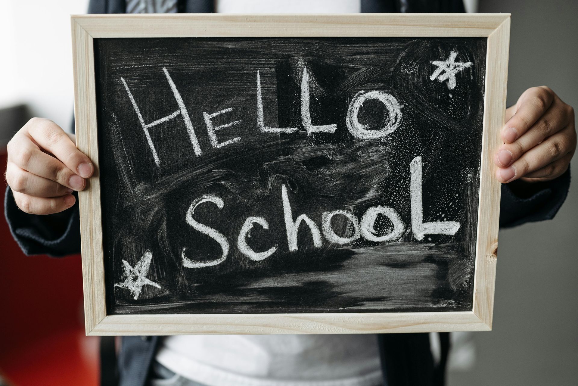 Person holding a chalkboard sign that says