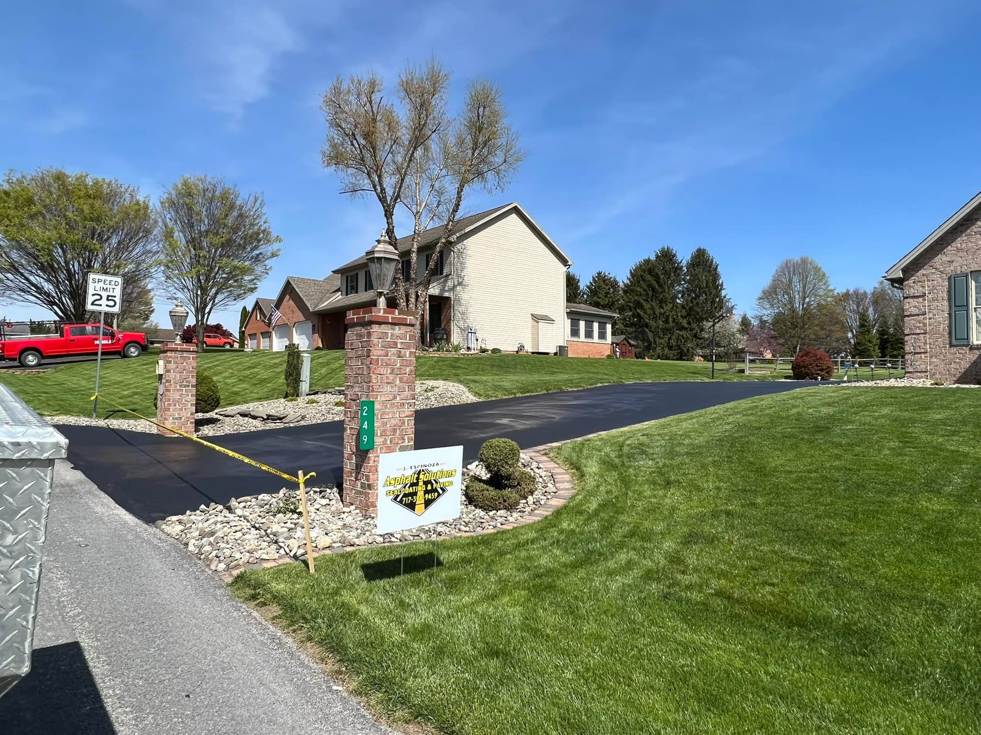 A driveway leading to a house in a residential area
