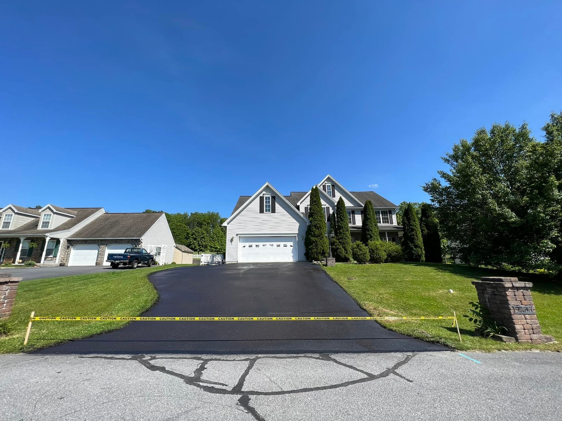 A house with a large driveway in front of it.
