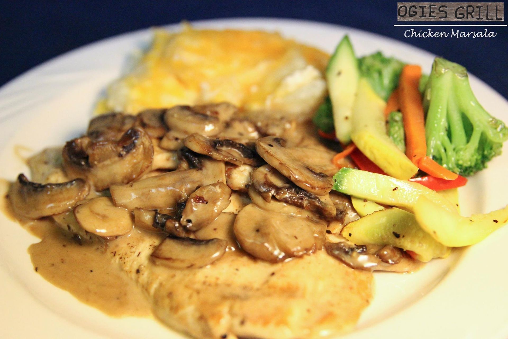 A white plate topped with chicken mushrooms and vegetables