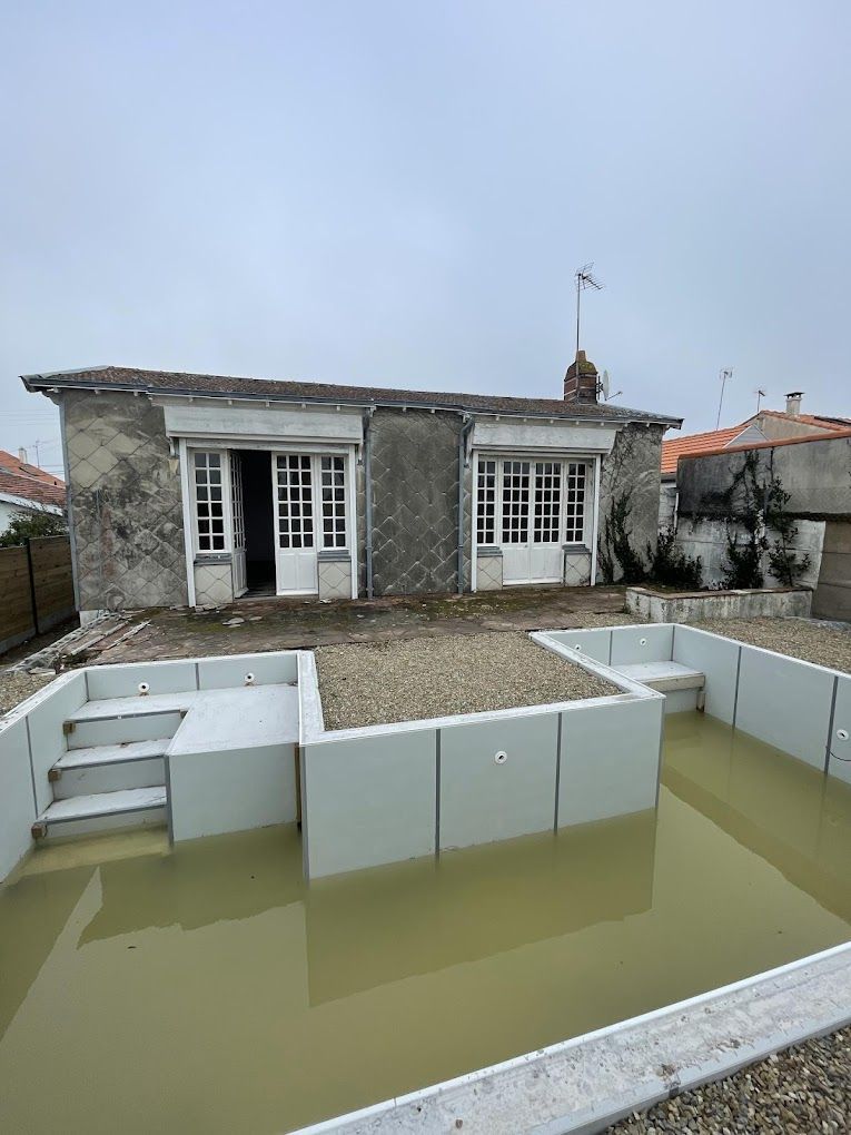 a house with a swimming pool in front of it