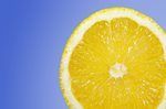 Cross-section of an orange against a bright blue background.