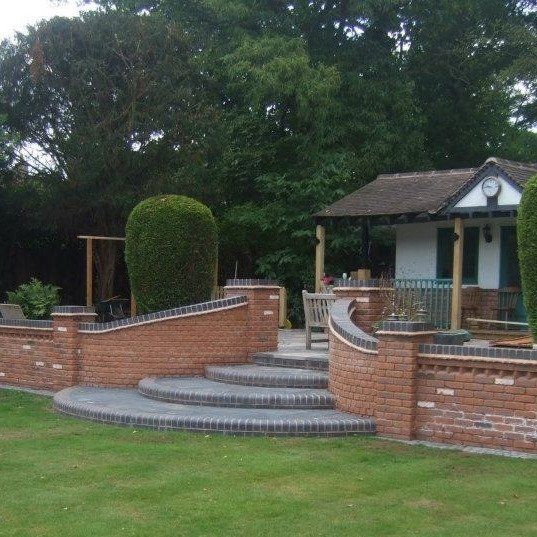 A modern outside building with steps, walls and patio