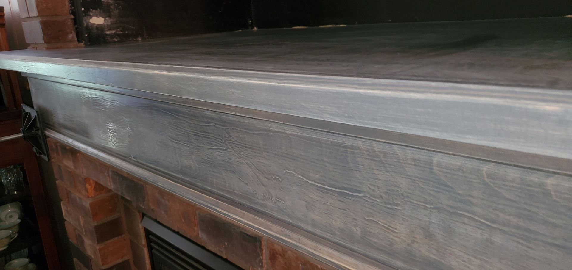 Close-up of a long metal industrial conveyor or worktable with a brushed silver surface