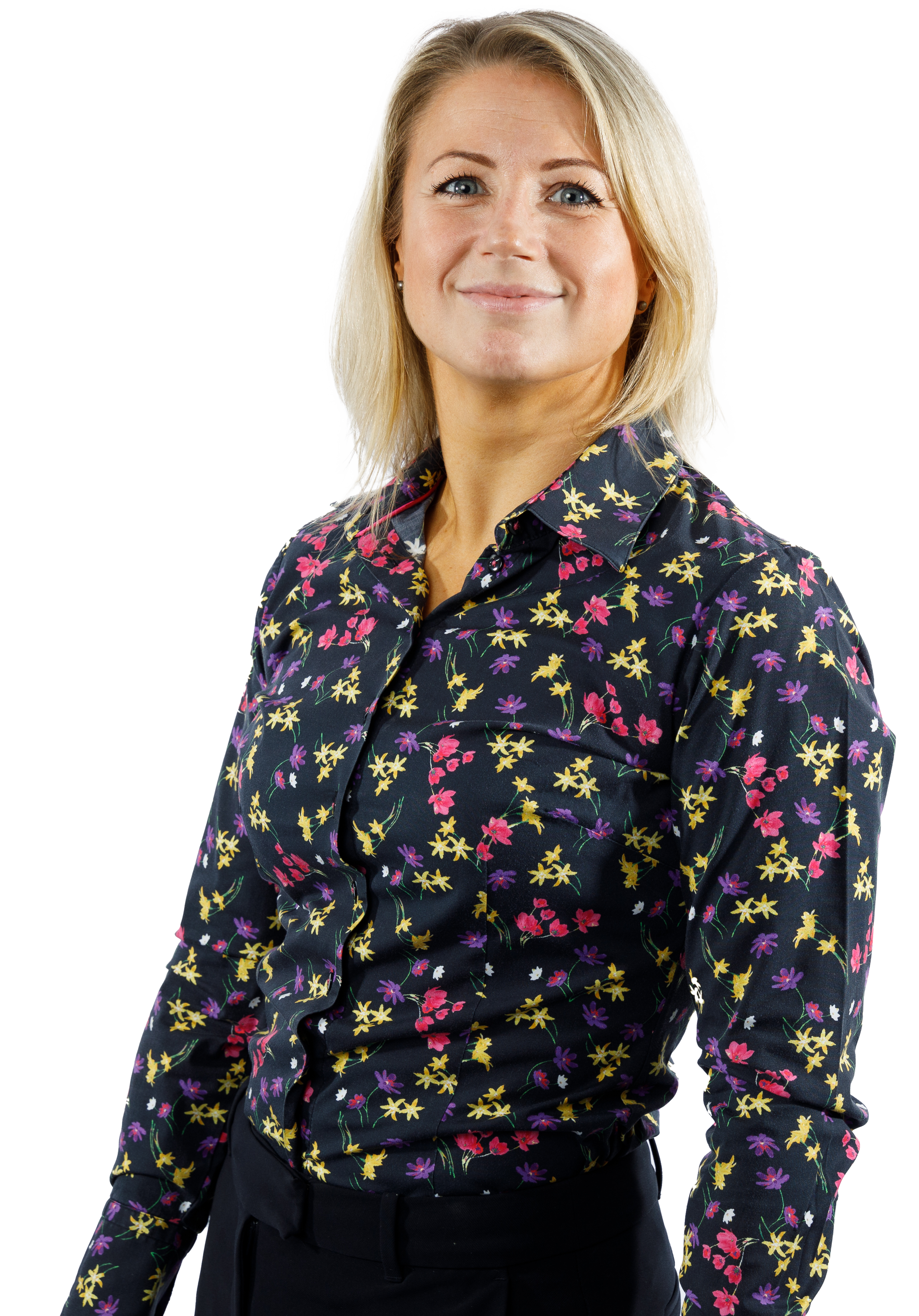 Woman smiling, wearing a floral print shirt, against a white background.
