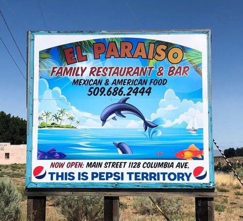 A large billboard design for El Paraiso Family Restaurant and Bar. It shows a dolphin jumping out of the ocean.