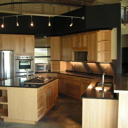 A kitchen with wooden cabinets and stainless steel appliances