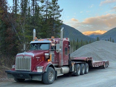 Winch tractor and super b trailers hauling well heads in Grande Prairie, Alberta