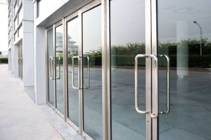 Glass entrance doors with metal handles on a modern building exterior