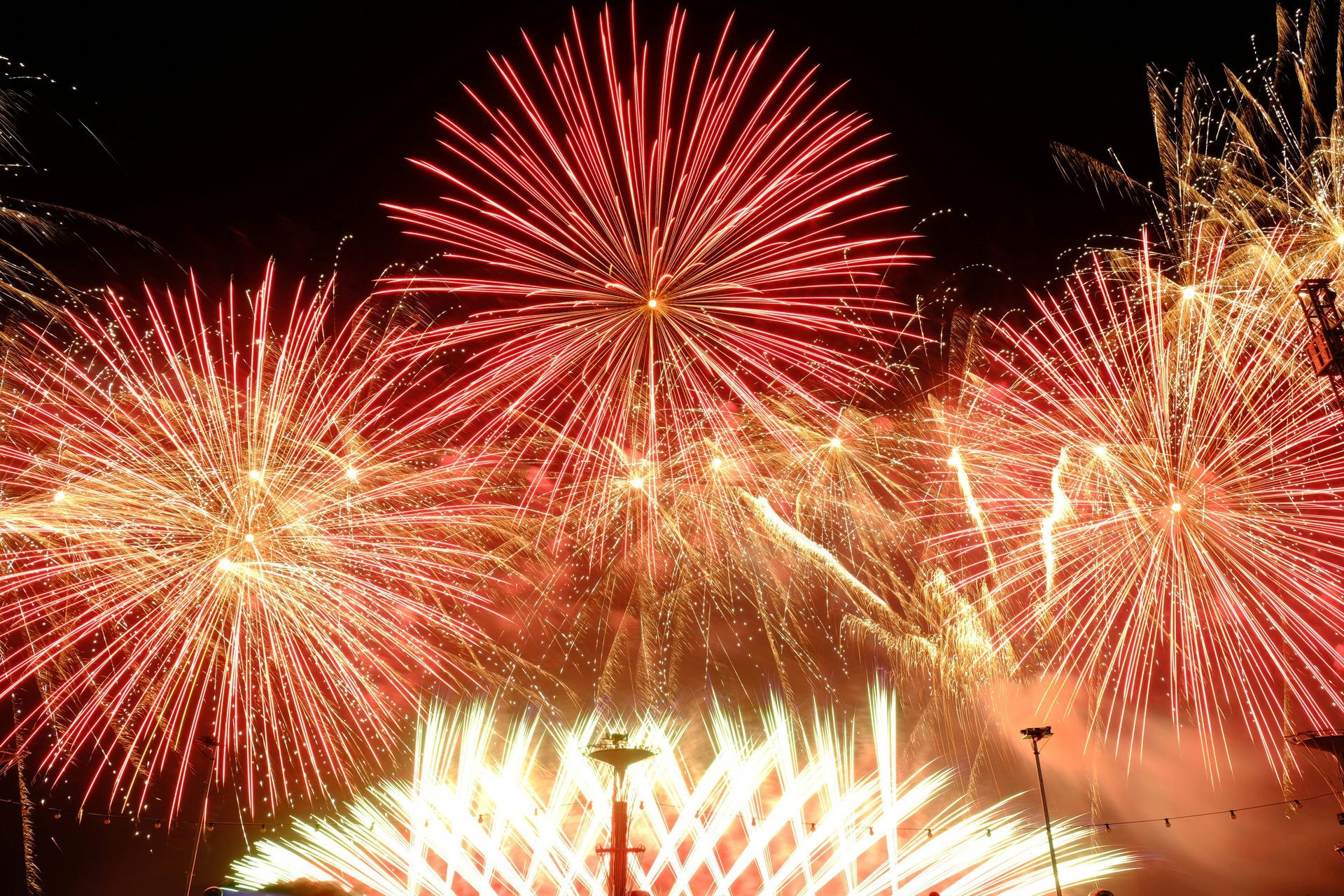 A bunch of fireworks are going off in the night sky