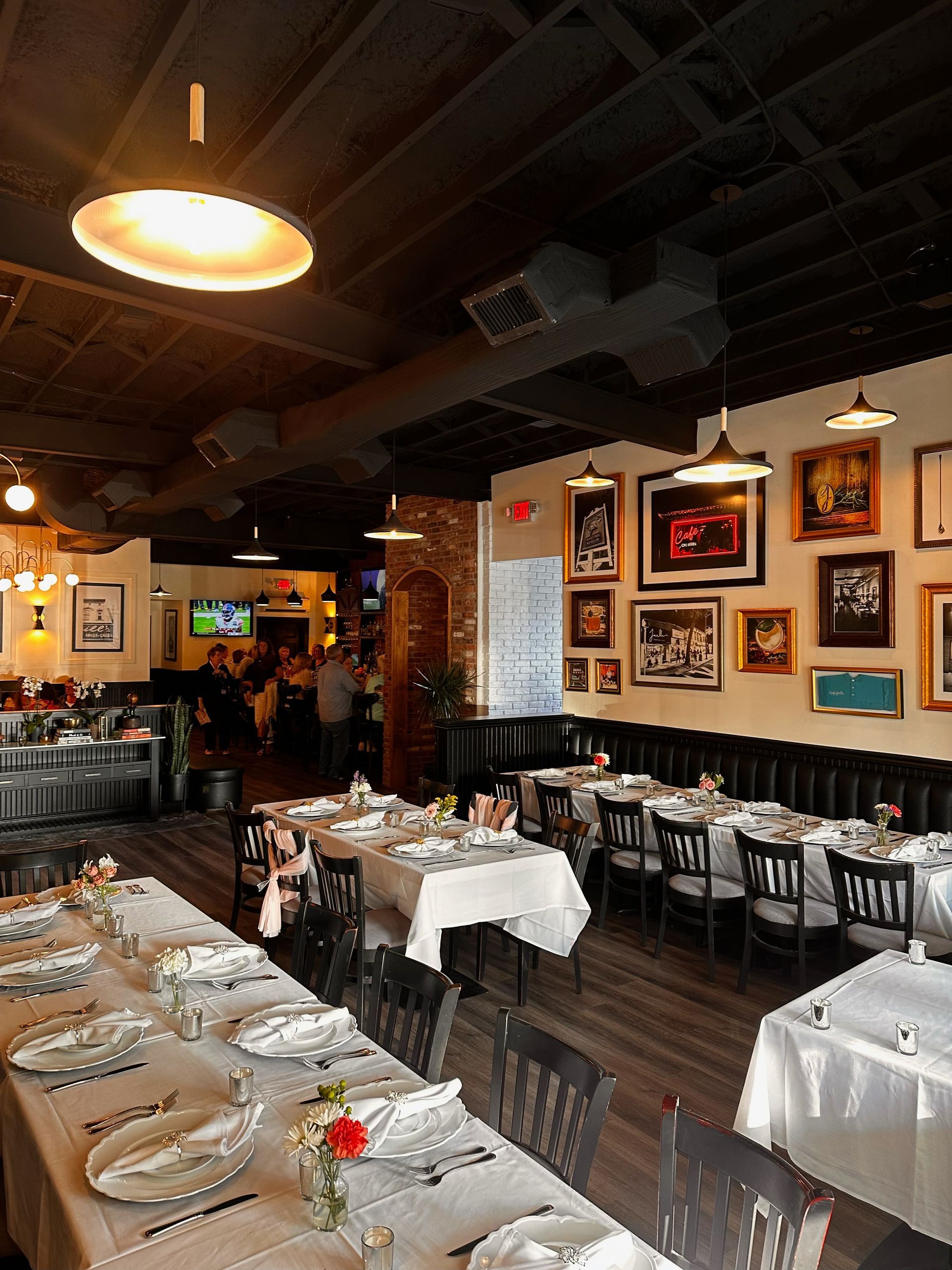 A restaurant with tables and chairs set up for dinner