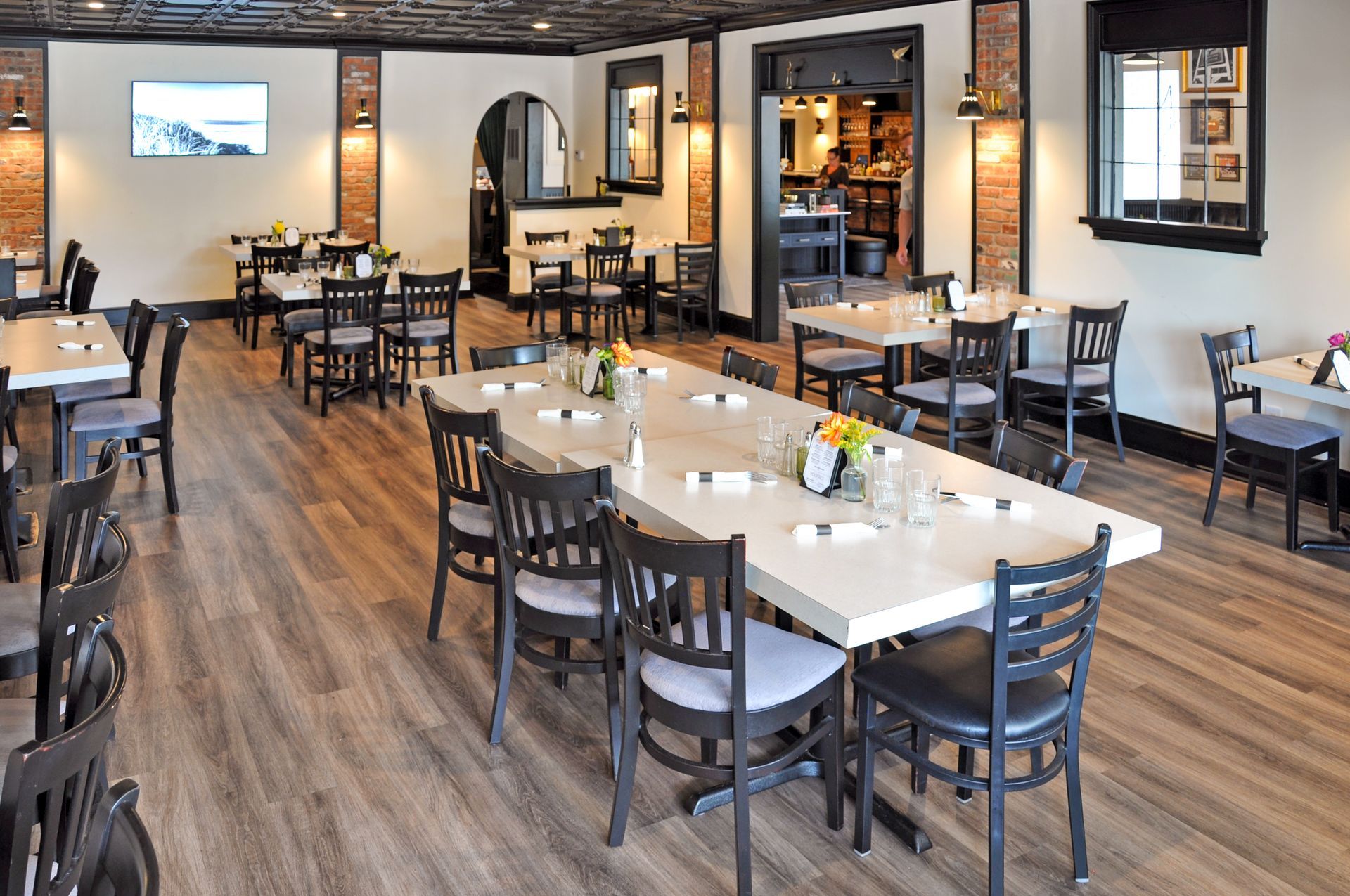 A restaurant with tables and chairs in a large room.