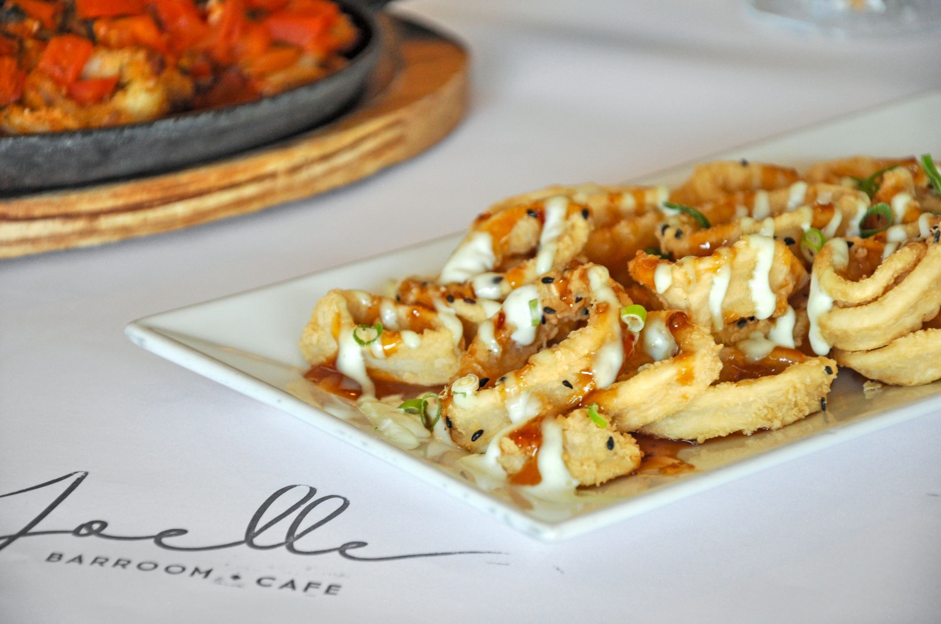 A white plate topped with french fries and sauce