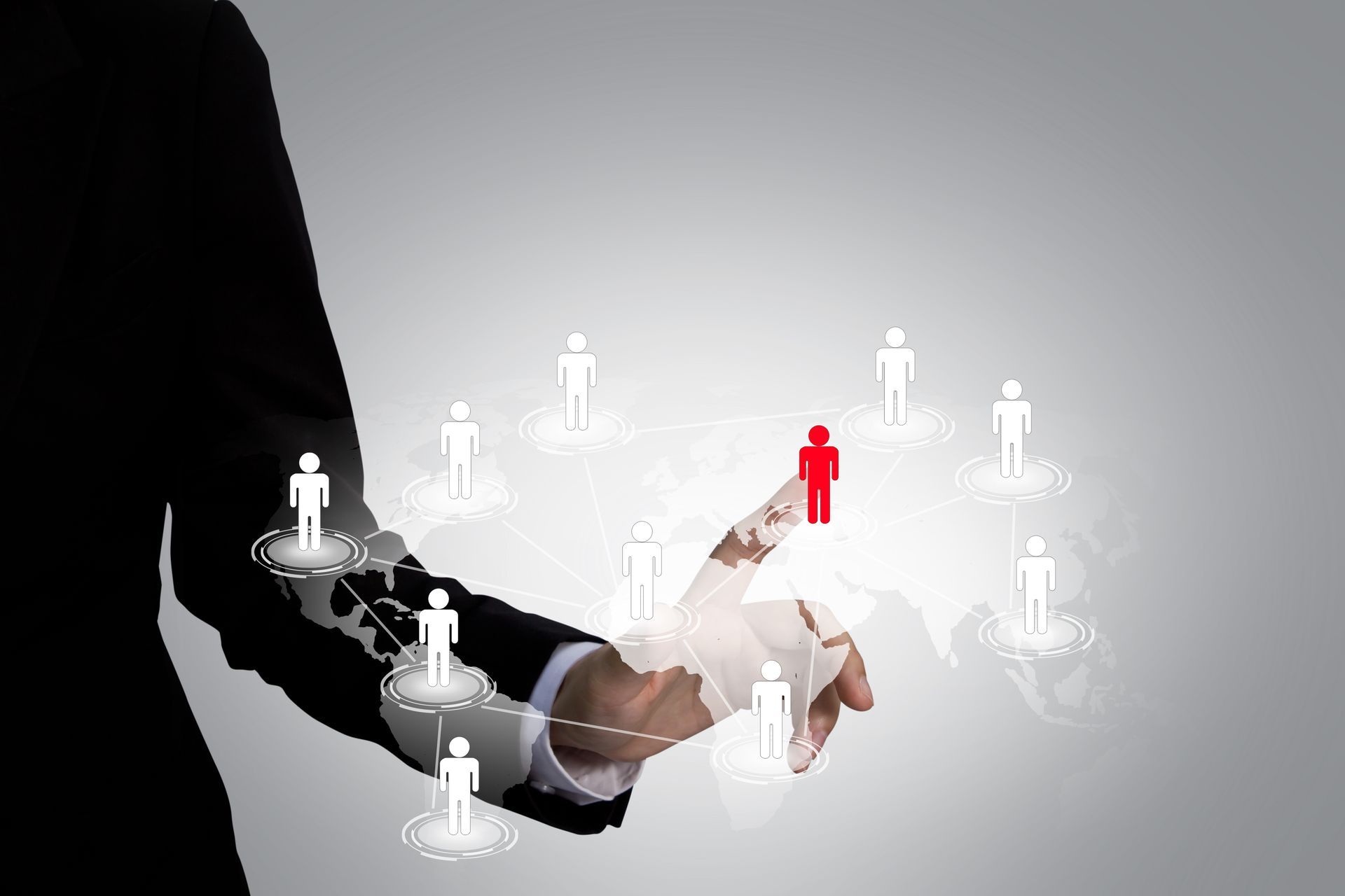 a person is holding a red person in their hand surrounded by white people .