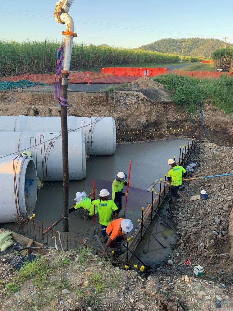 A Group of Construction Workers Are Working on A Construction Site — Mass Construction Group Australia Pty Ltd in South Mackay, QLD