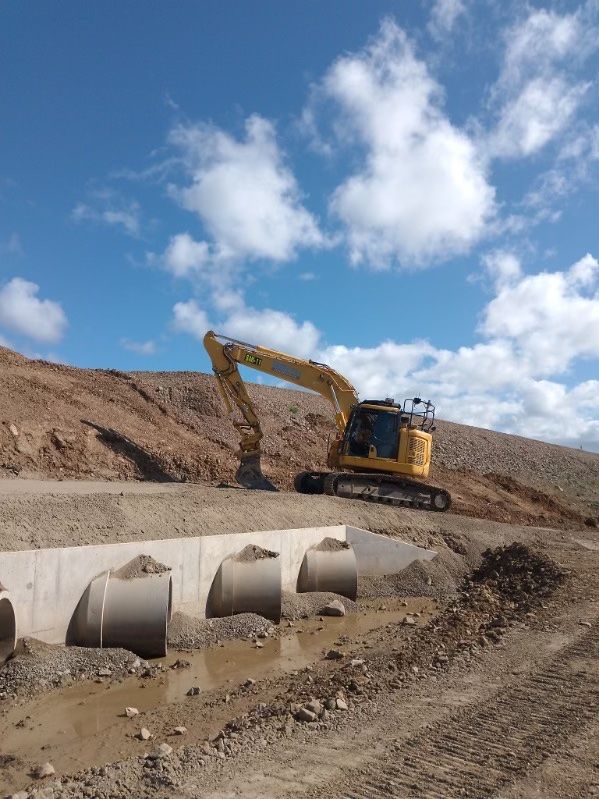A Yellow Excavator Is Working On A Construction Site — Mass Construction Group Australia Pty Ltd in South Mackay, QLD