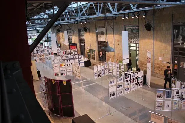 An aerial view of a large building with a lot of posters on the floor.