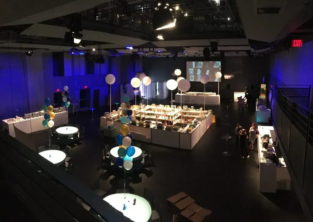 A large room with tables and balloons in it