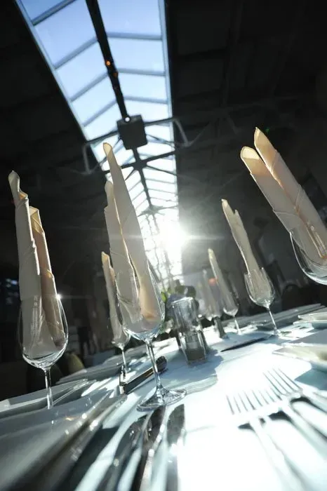 A table with a lot of glasses and napkins on it