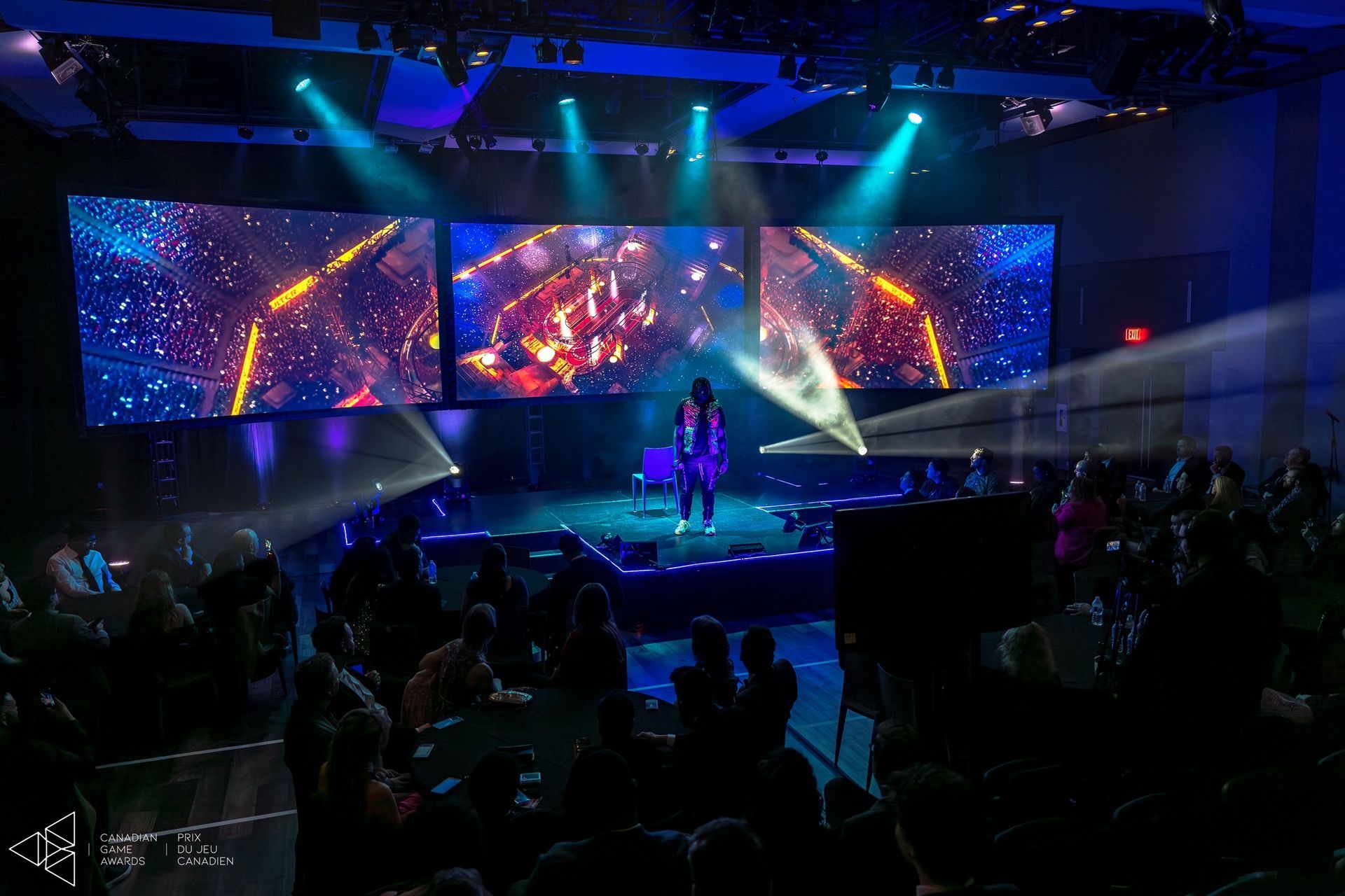 A woman singing on a stage in front of a crowd