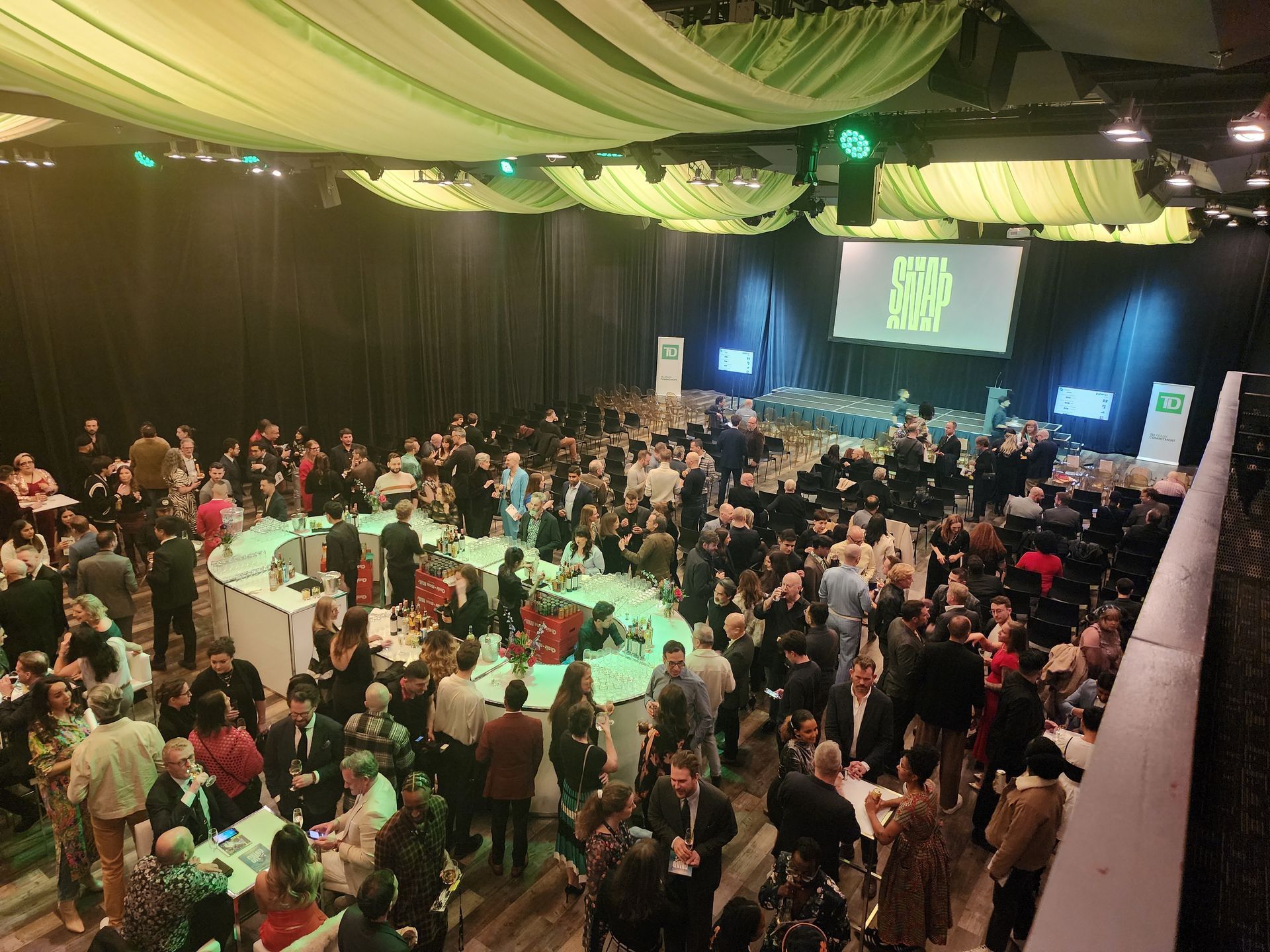 A large group of people are gathered in a large room.