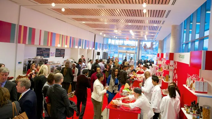 A large group of people are gathered in a large room.