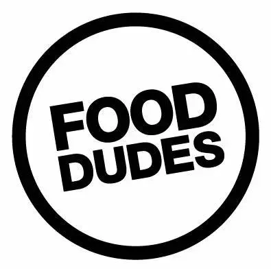 The logo for food dudes is a black and white circle with the words `` food dudes '' written inside of it.